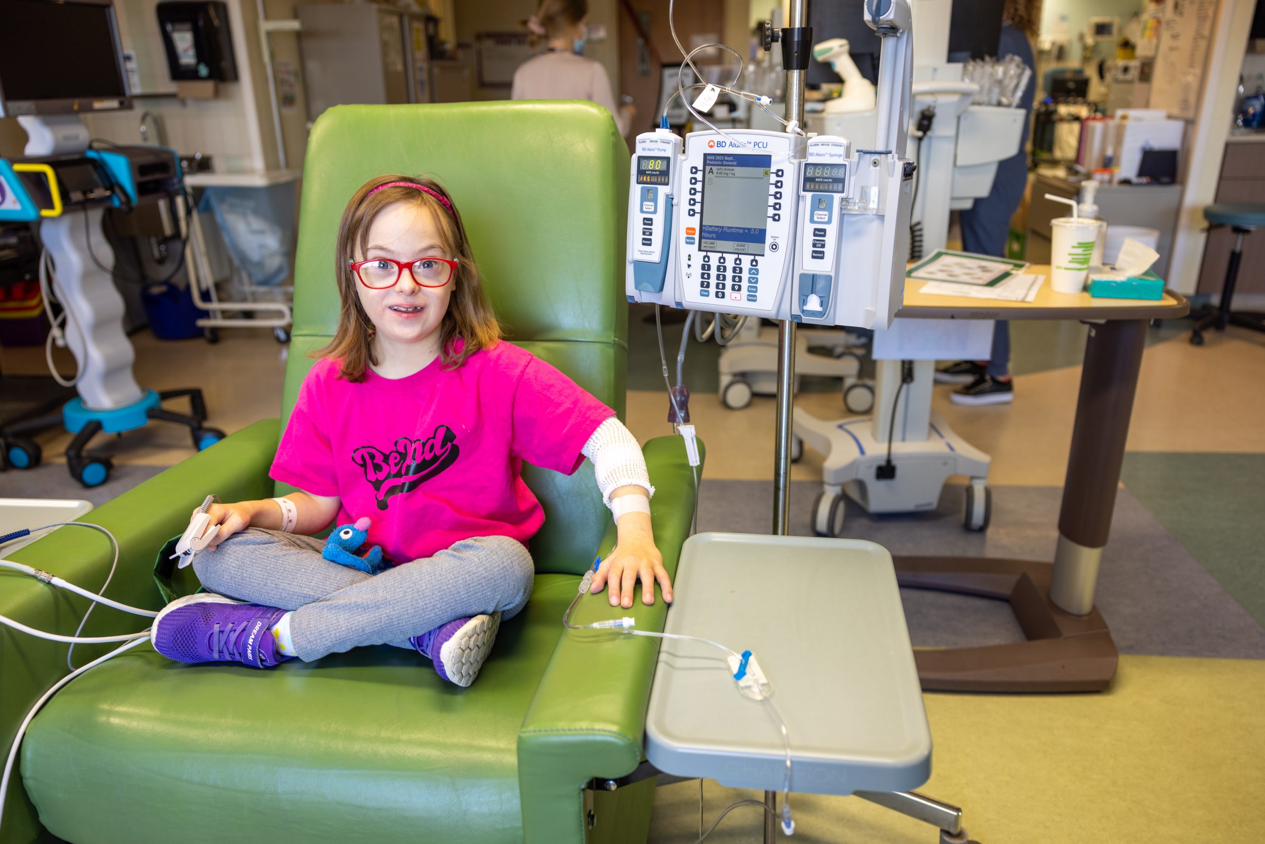 HHS child patient seated while undergoing treatment.
