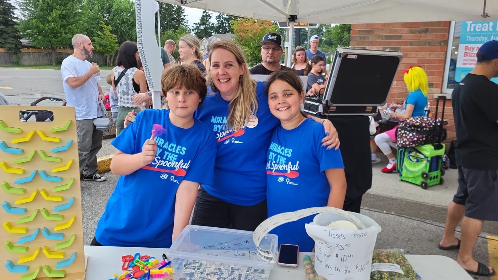 MacKids fundraising event volunteers smiling together