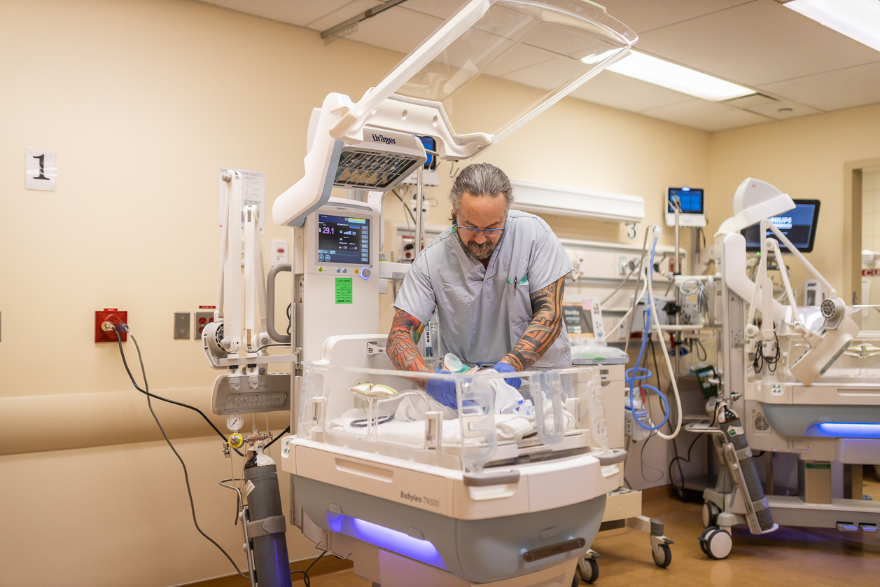 NICU nurse tending to an infant patient