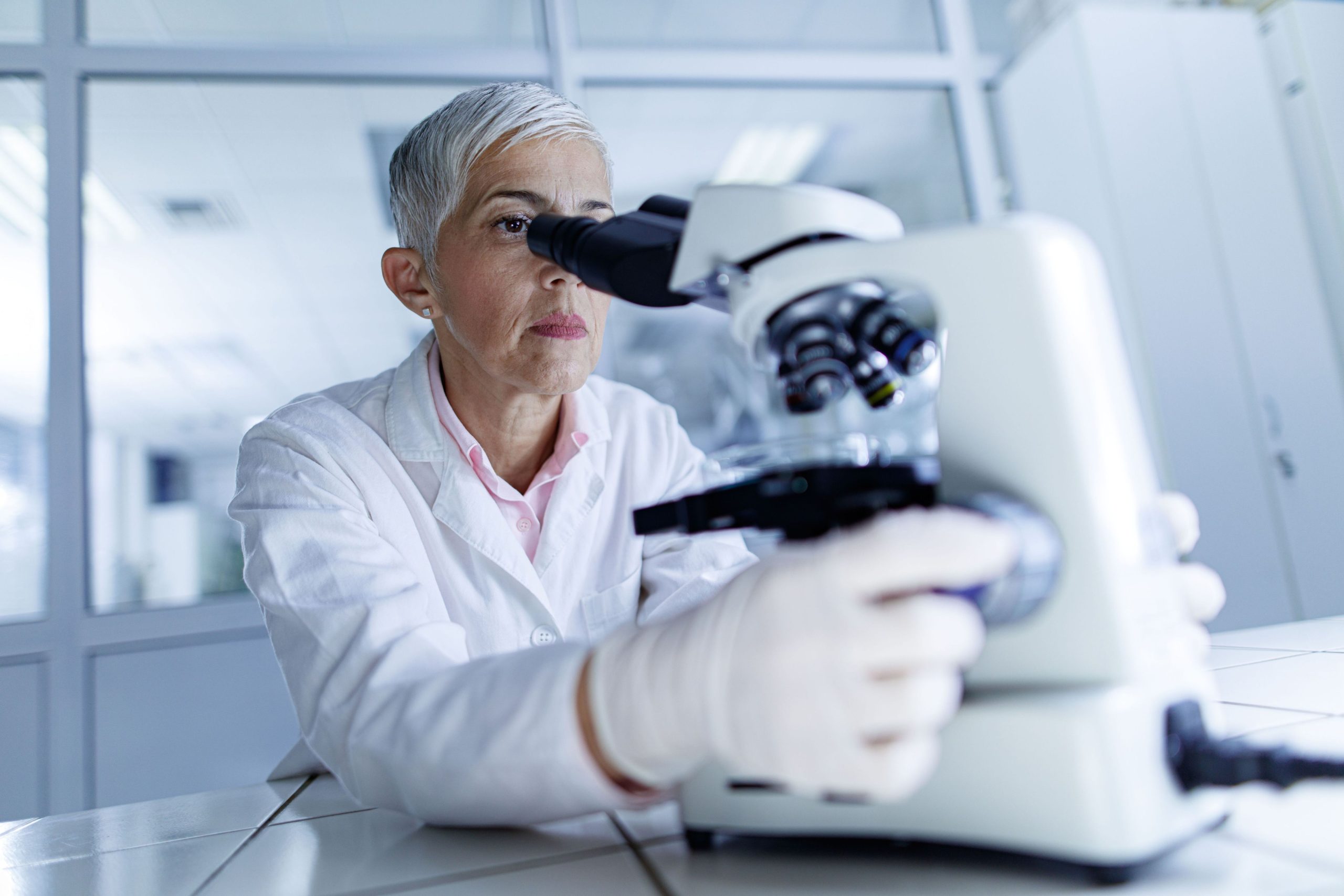 Medical doctor looking through a microscope
