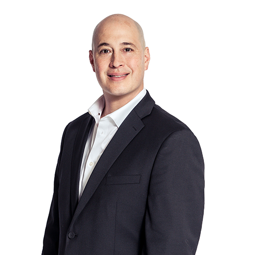 Image of man in black suit, white shirt