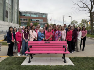 Group of BRIGHT Run organizers, supporters and healthcare staff gathered behind a bright pink commemorative bench outside Juravinski Hospital and Cancer Centre in honour of the community event’s support for breast cancer research.