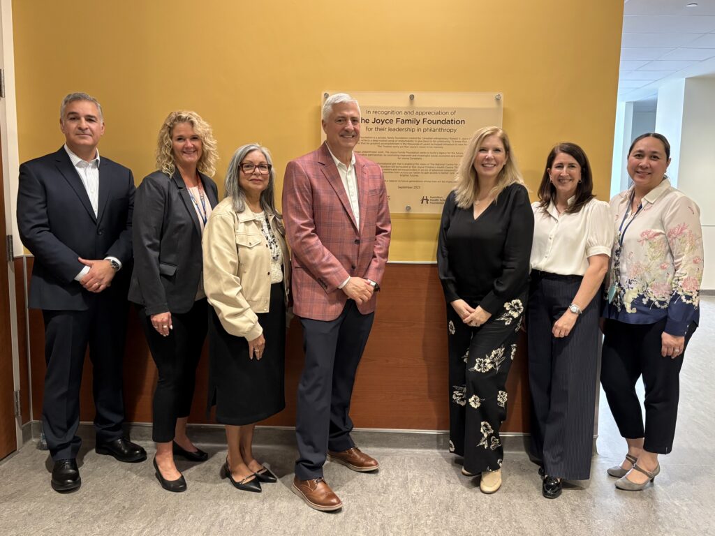 Group of partners and leaders beside a plaque recognizing the Joyce Family Foundation’s support for the National Centre for Autism Collaboration at Ron Joyce Children’s Health Centre
